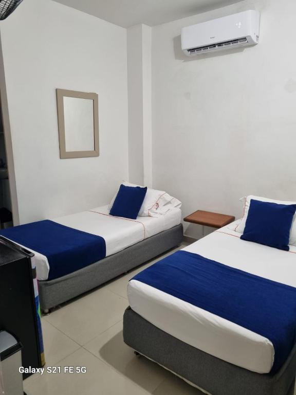 Postel nebo postele na pokoji v ubytování Hotel Casa 10