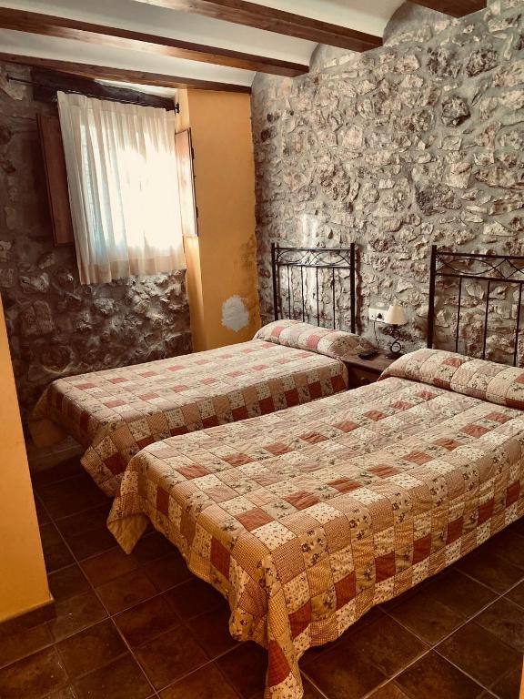 Postel nebo postele na pokoji v ubytování Hostal La Muralla