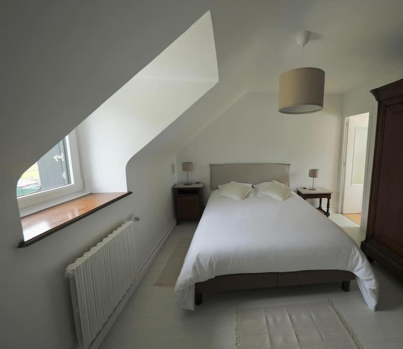 une chambre avec un lit blanc et une fenêtre dans l'établissement Ti Ar Familhou classée 3 étoiles, à Paimpol