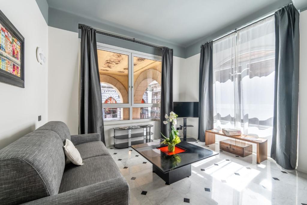 a living room with a couch and a large window at Giada Home Luxury in Genova City Centre in Genova