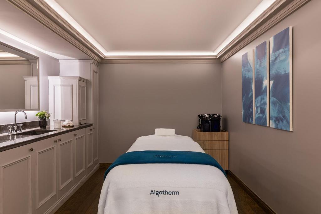 a small room with a bed and a sink at InterContinental Paris Le Grand by IHG in Paris
