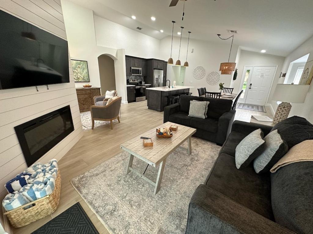 a living room with a couch and a table at South Facing Pool Villa Spa Remodeled Floor to Ceiling Southern Dunes in Haines City