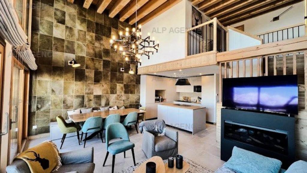 a living room with a large tv and a couch and chairs at Résidence Alpine Loft - 5 Pièces 10 pers- HAUT DE GAMME - ALPINE LOFT - 10ALPI-PLAGNE CENTRE MAE-2634 in Aime La Plagne