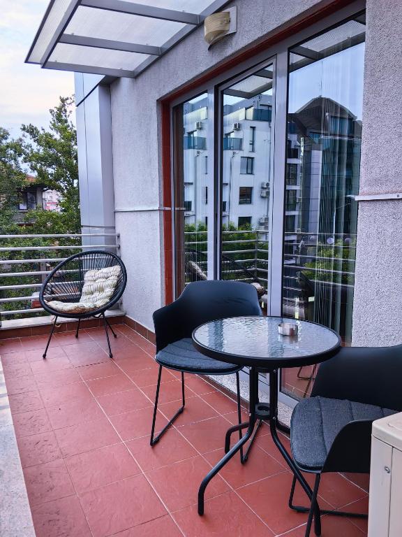 a patio with a table and chairs on a balcony at The View Apartment in Plovdiv