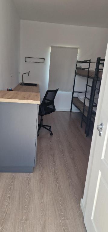 an office with a desk and a chair in a room at Florin Olarean in Marginea