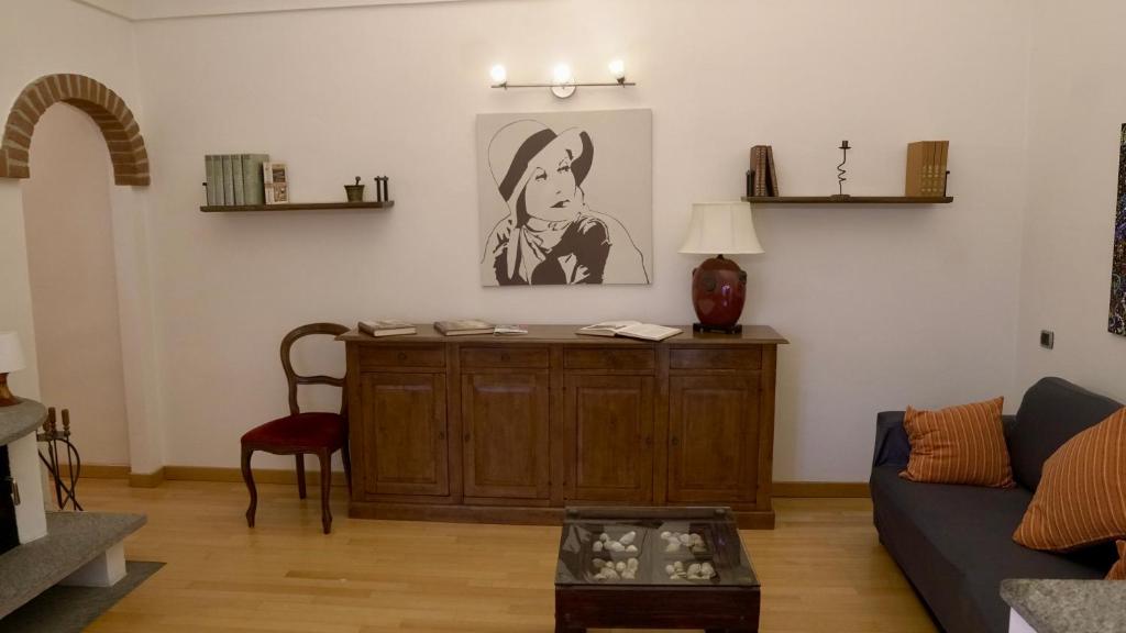 a living room with a couch and a table at La Casa di Anita in Asti