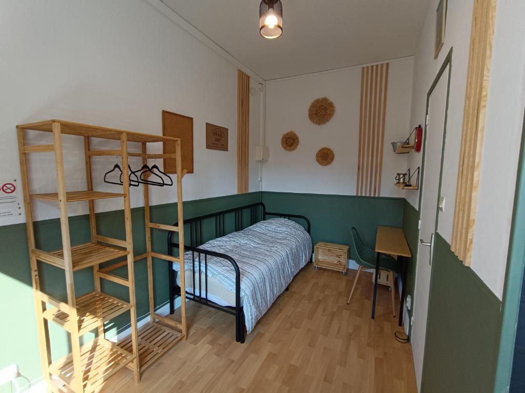 a bedroom with a bed and a book shelf at Les Madeleines de Saint-Omer in Saint-Omer