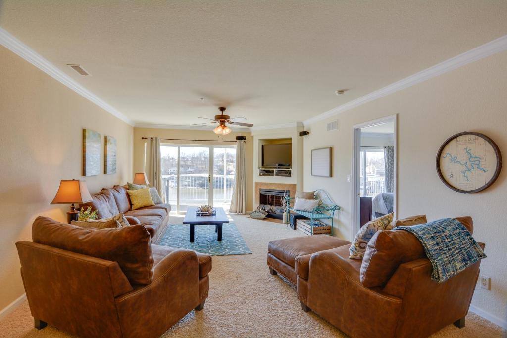 a living room with two chairs and a couch at Lake Views and Pool Access Osage Beach Condo in Osage Beach