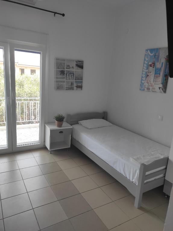 Postel nebo postele na pokoji v ubytování Noula Rooms