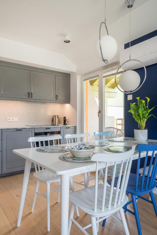 a kitchen with a white table and chairs at Sopot M16 - by JWPM in Sopot