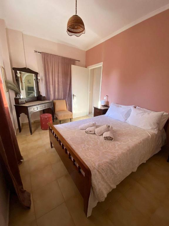 a bedroom with a large bed with towels on it at Palaiopolis house in Kanoni