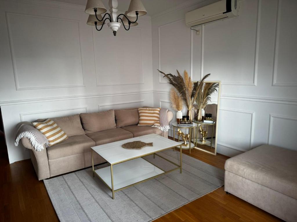 a living room with a couch and a table at Sea apartment Bar in Bar