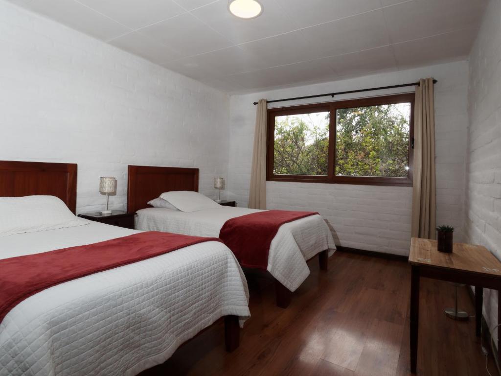 Postel nebo postele na pokoji v ubytování Apartamentos Otorongo Cuenca Ecuador
