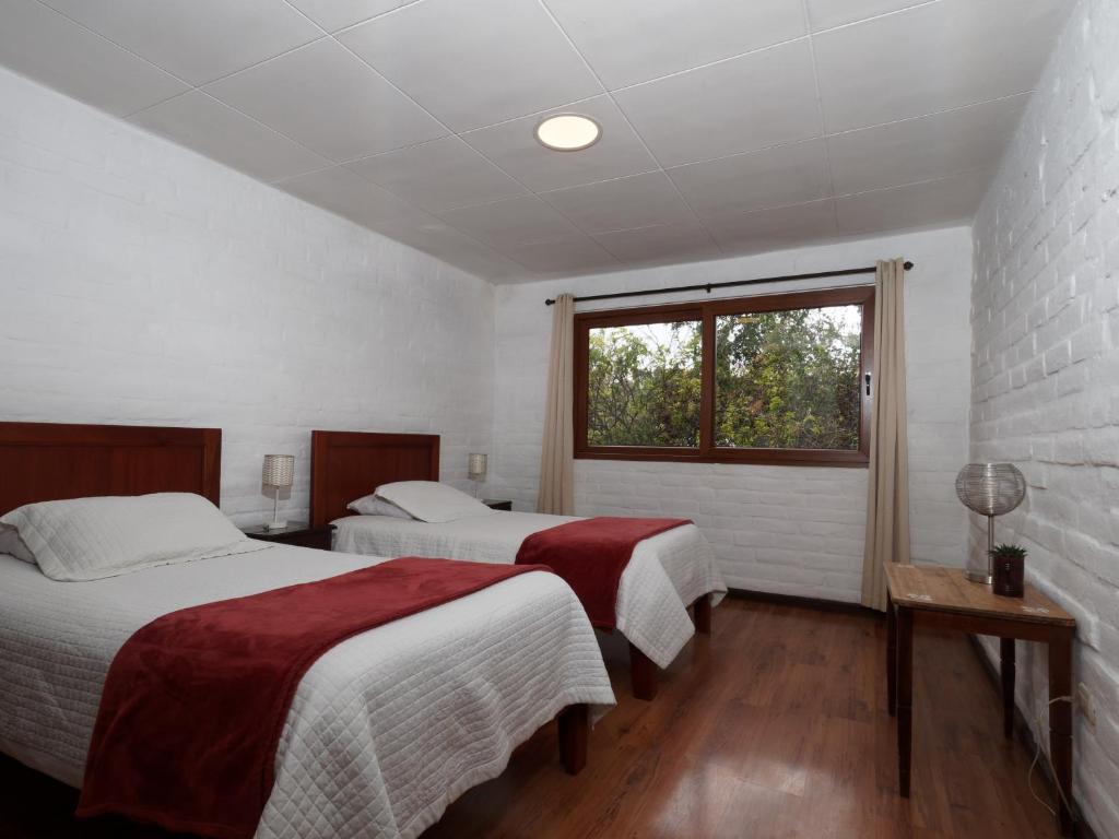 Postel nebo postele na pokoji v ubytování Apartamentos Otorongo Cuenca Ecuador