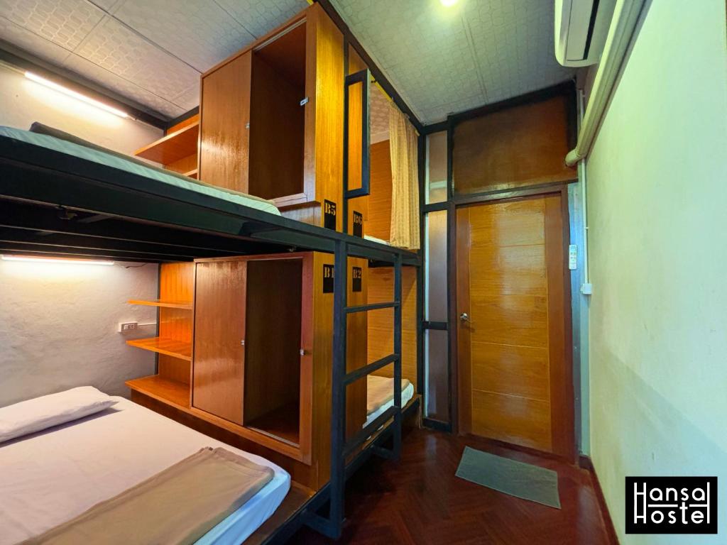 a small room with bunk beds and a hallway at Hansa Hostel Bangkok Khaosan in Bangkok