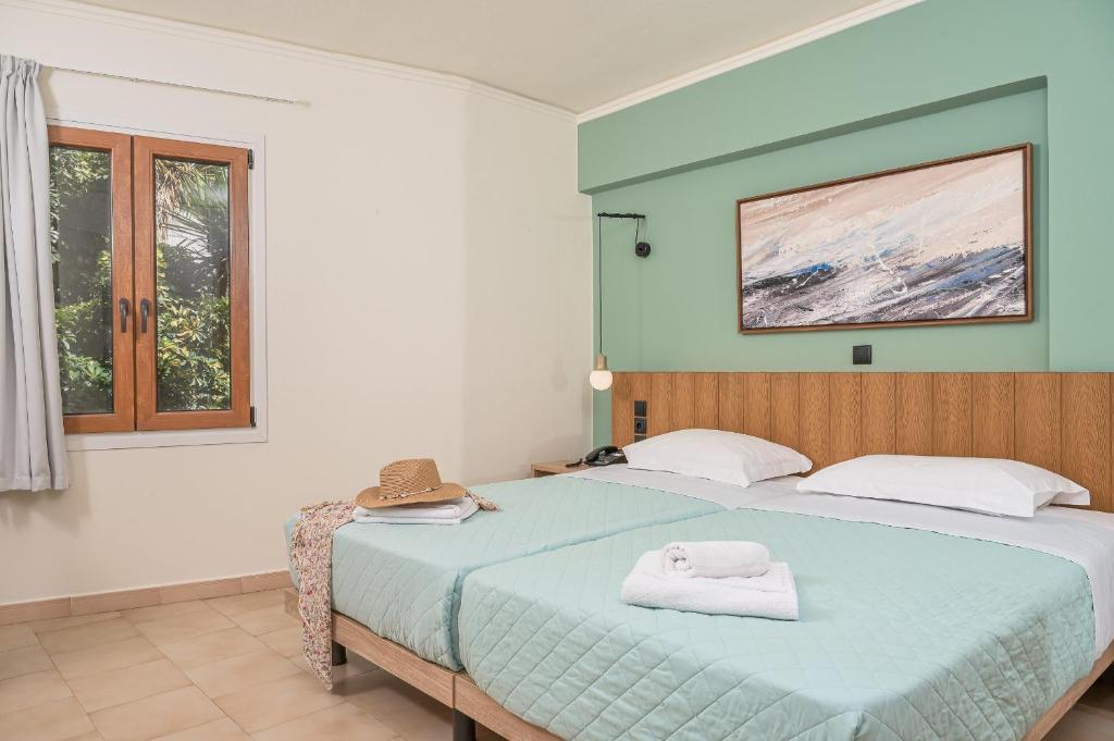 A bed or beds in a room at Emily Hotel