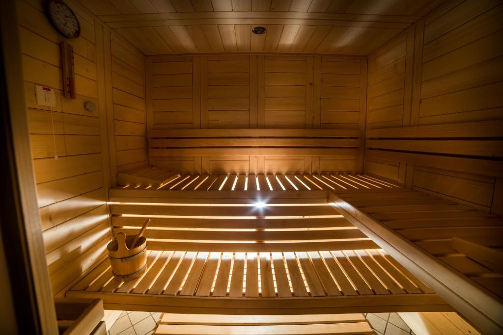 an empty wooden sauna with a spotlight in it at Hotel Marina in Izola