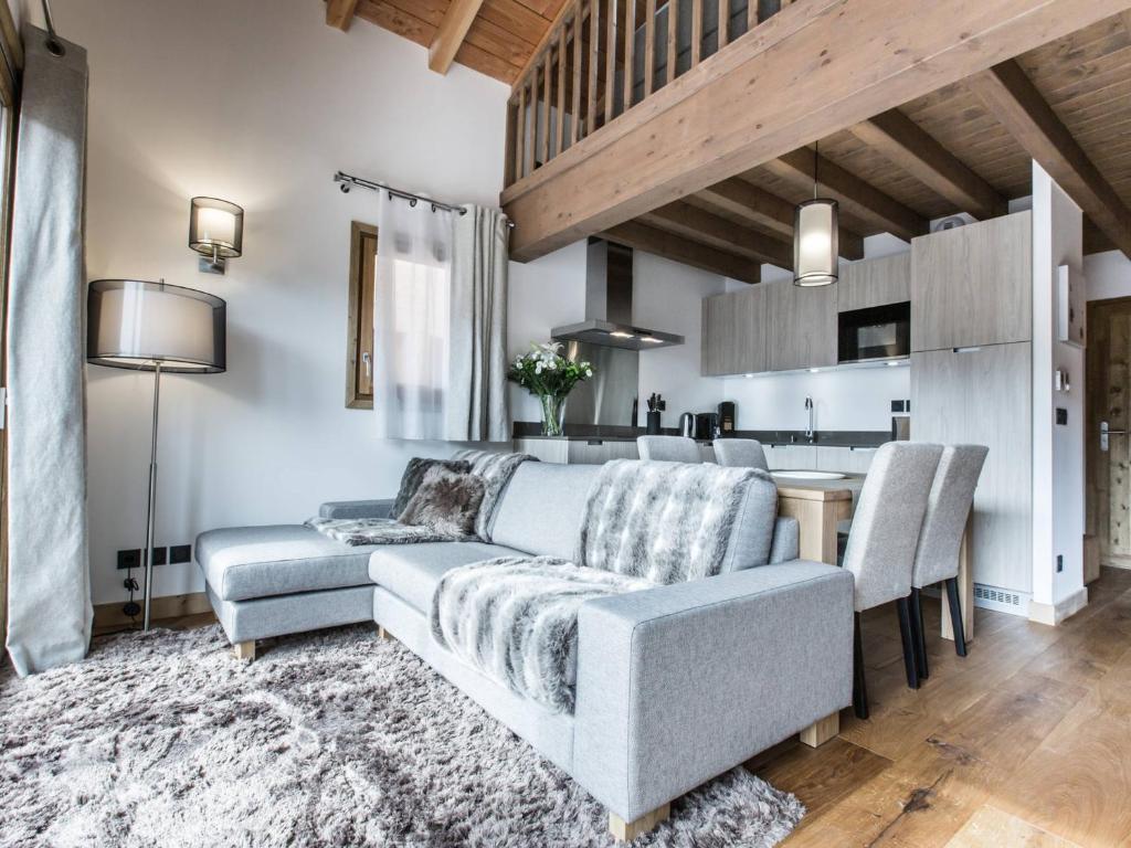 a living room with a couch and a table at Appartement Souplex Chaleureux aux Gets - 4 pers, 2 Ch. en Suite, proche du Centre et des Pistes - FR-1-598-170 in Les Gets