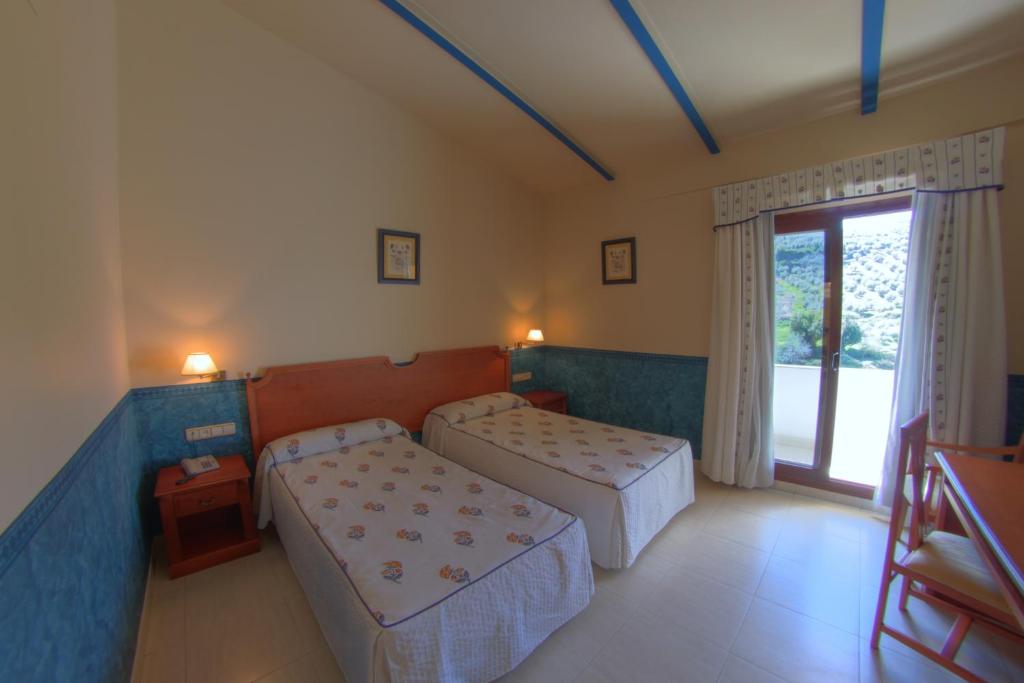 Postel nebo postele na pokoji v ubytování Hotel Avenida