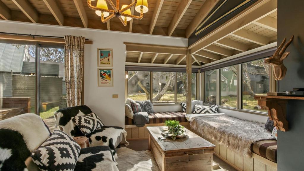 a living room with a couch and a large window at Aaragon in Dinner Plain