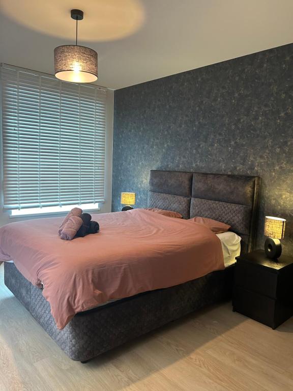 a bedroom with a bed with a teddy bear on it at Oostendelle in Ostend