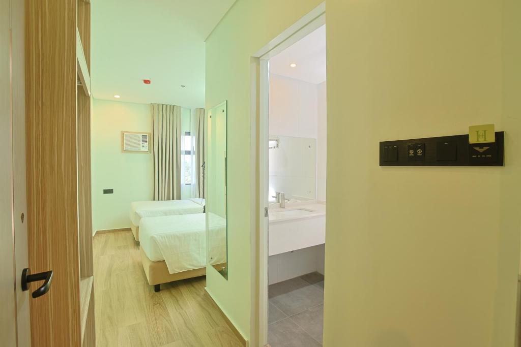Postel nebo postele na pokoji v ubytování Hamersons Hotel CDO