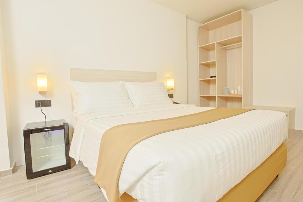 Postel nebo postele na pokoji v ubytování Hamersons Hotel CDO