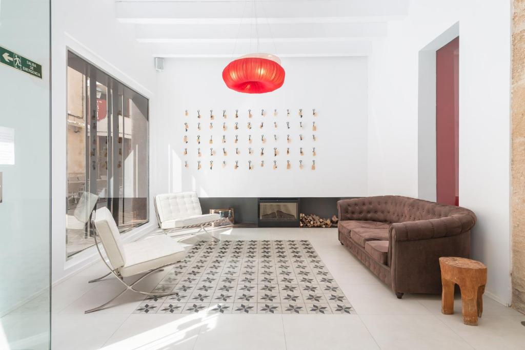 a living room with a couch and a fireplace at Hotel Can Simo in Alcudia