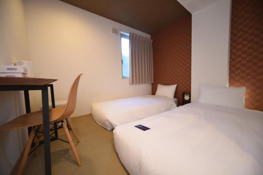 Postel nebo postele na pokoji v ubytování HOTEL WAN OSAKA EBISU