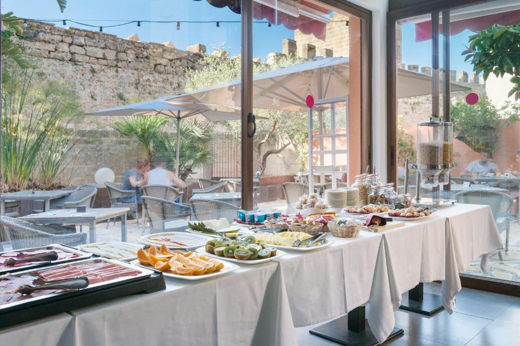 a buffet of food on a table in a restaurant at Hotel Can Simo in Alcudia