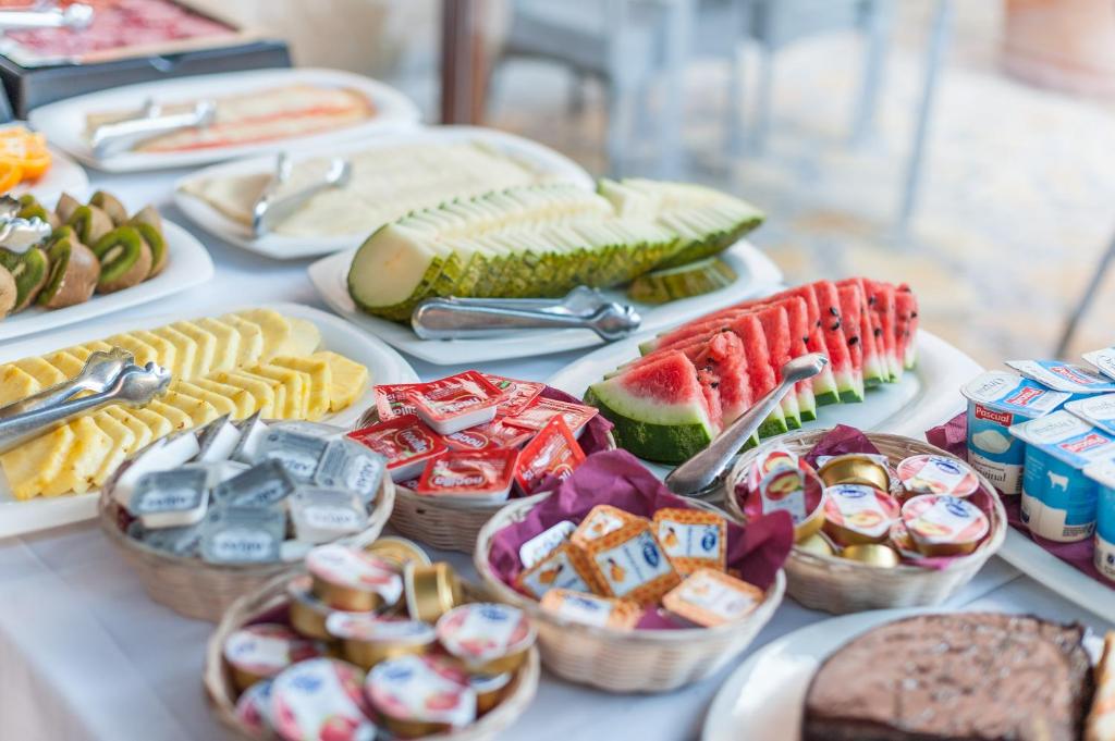 a table topped with plates of food and snacks at Can Vent Boutique Hotel in Alcudia