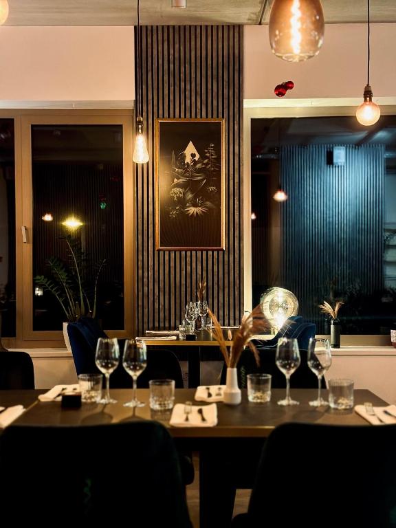 a dining room with a table with wine glasses at Berdorfer Eck - Bed&Breakfast in Berdorf