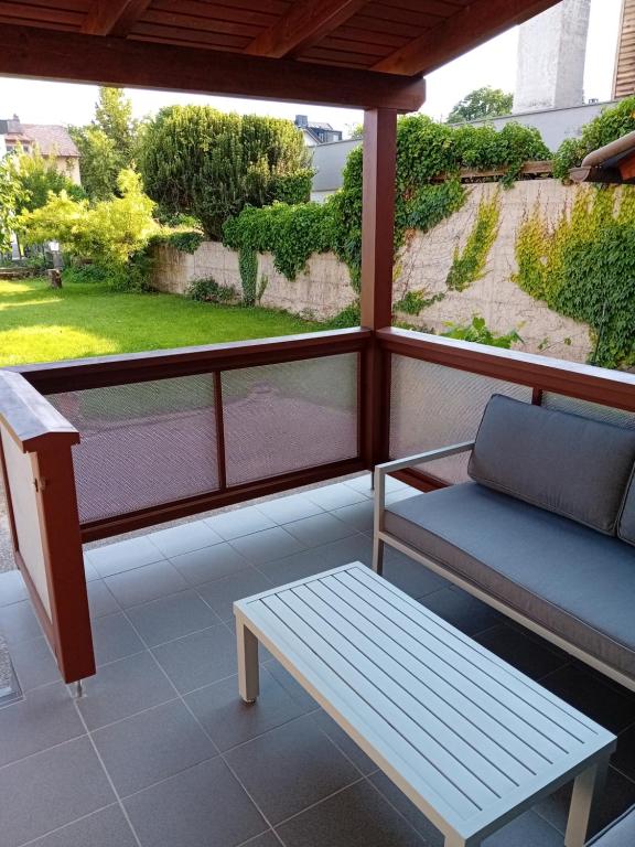 a screened porch with a bench and a table at Lind-Appartments in Villach
