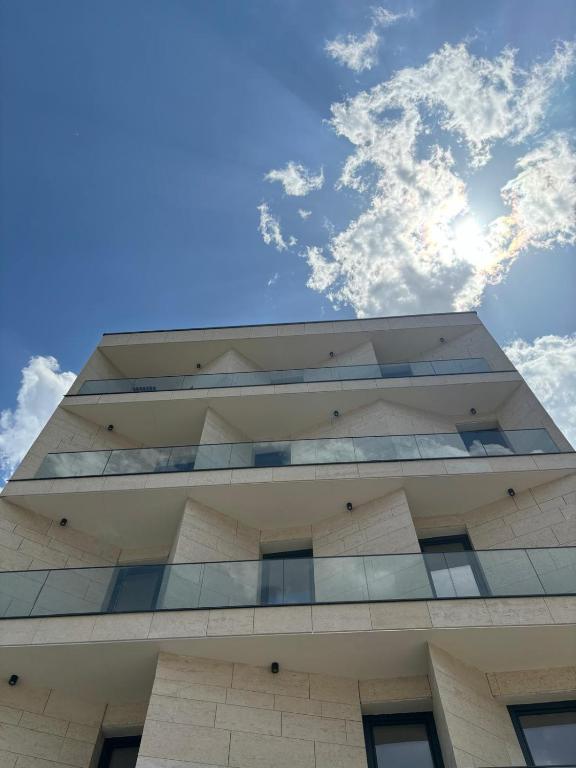 a tall building with the sky in the background at V25Appartments in Bucharest