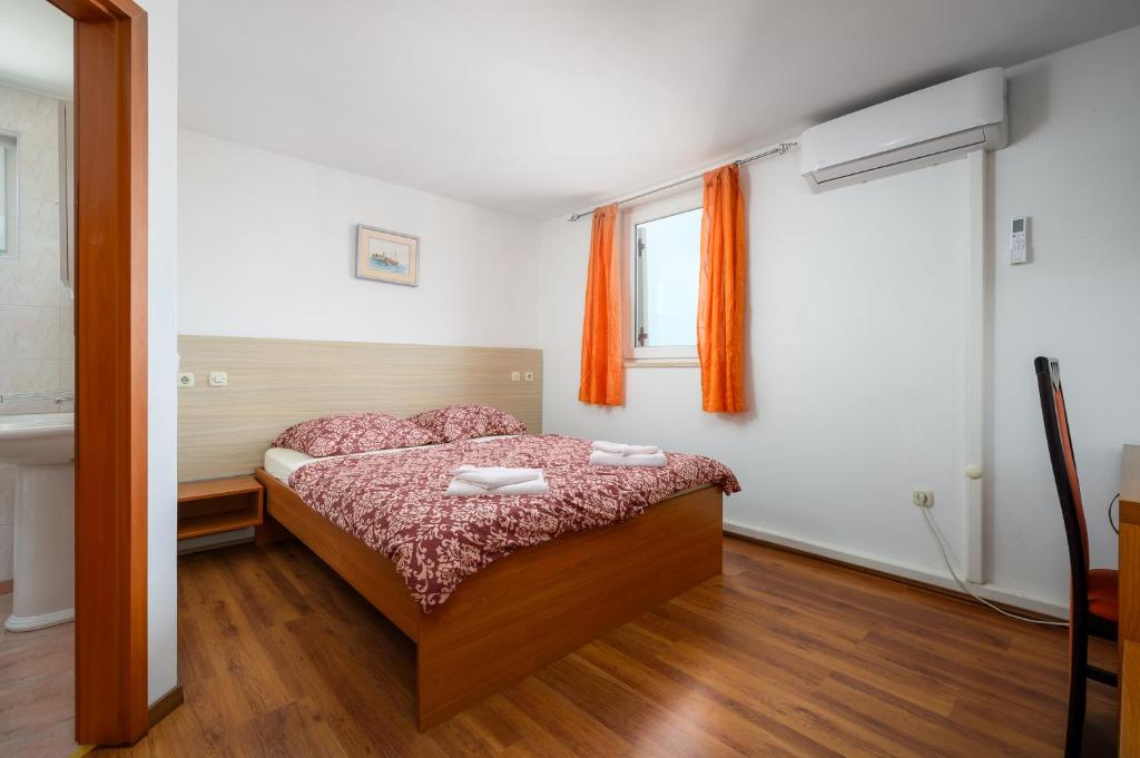 Postel nebo postele na pokoji v ubytování Ven Apartmani