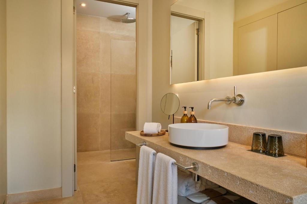 a bathroom with a sink and a mirror and a shower at Sant Jaume Design Hotel in Palma de Mallorca