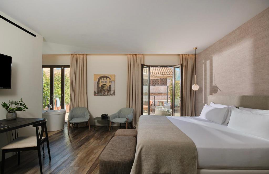 a hotel room with a large bed and a desk at Sant Jaume Design Hotel in Palma de Mallorca