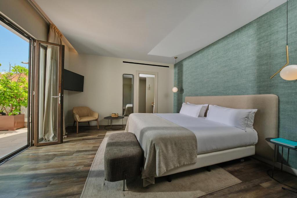a hotel room with a bed and a balcony at Sant Jaume Design Hotel in Palma de Mallorca