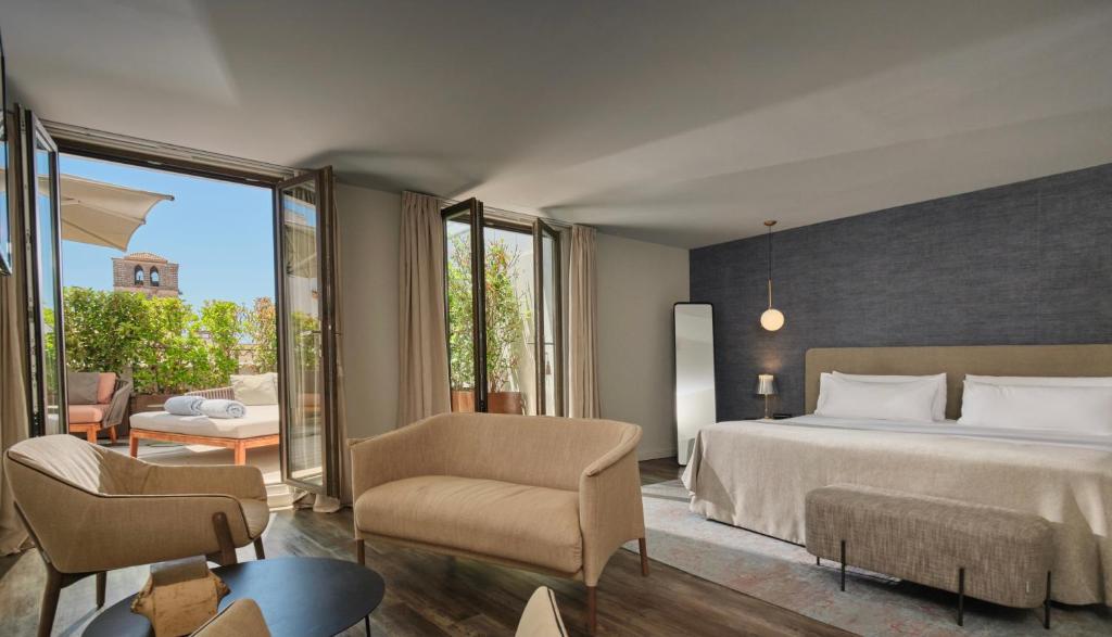 a hotel room with a bed and a balcony at Sant Jaume Design Hotel in Palma de Mallorca