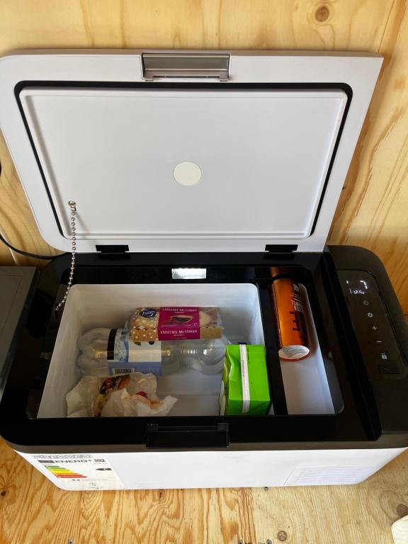 an open refrigerator with food inside of it at KoloCabins -Huuhanranta 6 in Ruokolahti