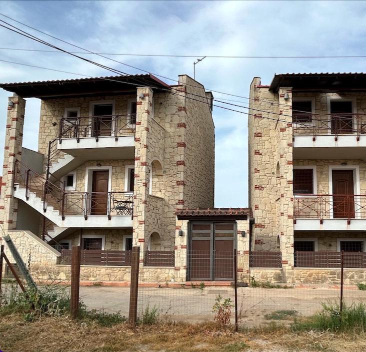 a large brick building with balconies on it at Stone House in Afytos in Afitos