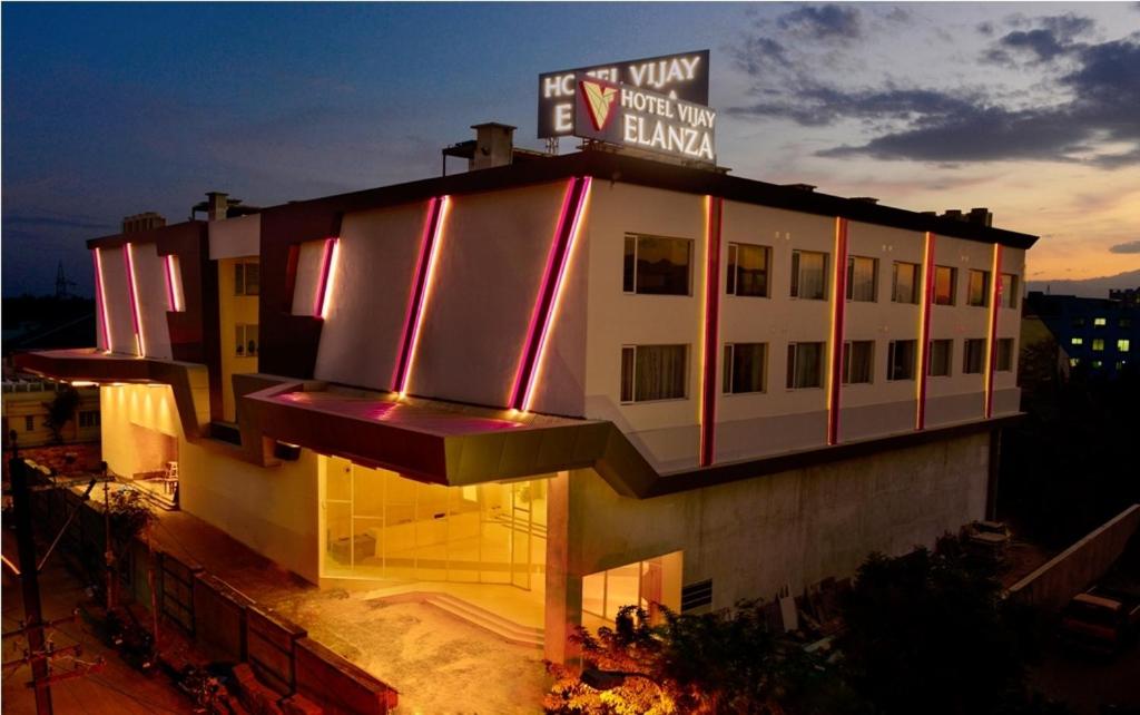 a building with a sign on the top of it at Hotel Vijay Elanza in Coimbatore