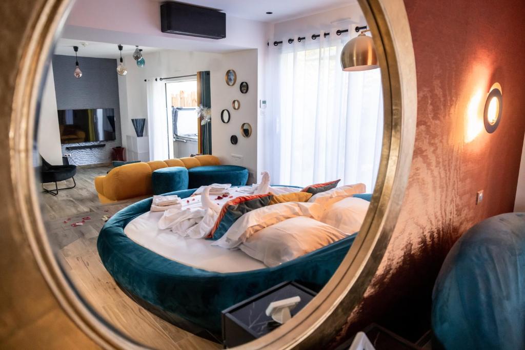 a bedroom with a large bed in front of a mirror at Résidence La Chaize in Noirmoutier-en-l'lle
