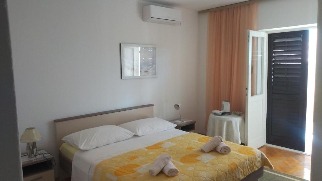 a bedroom with a bed with two towels on it at Guest house Milic in Makarska