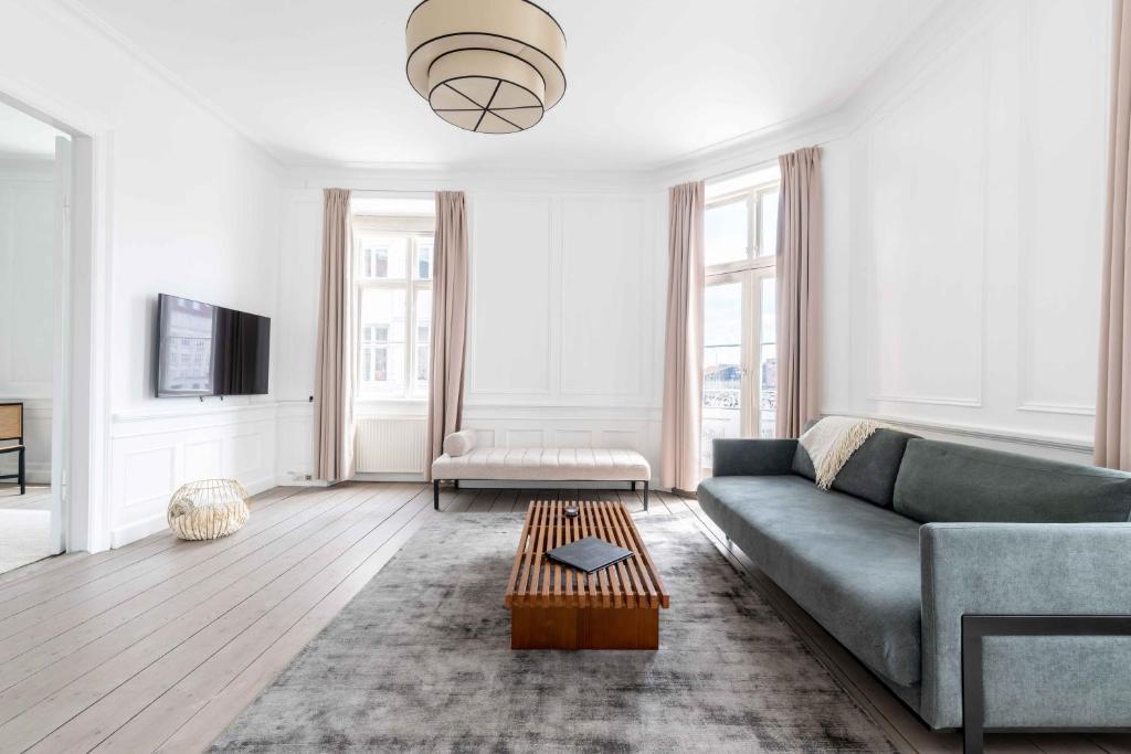 a living room with a couch and a table at Chic Apartment in Vibrant Area by Copenhagen Canals in Copenhagen
