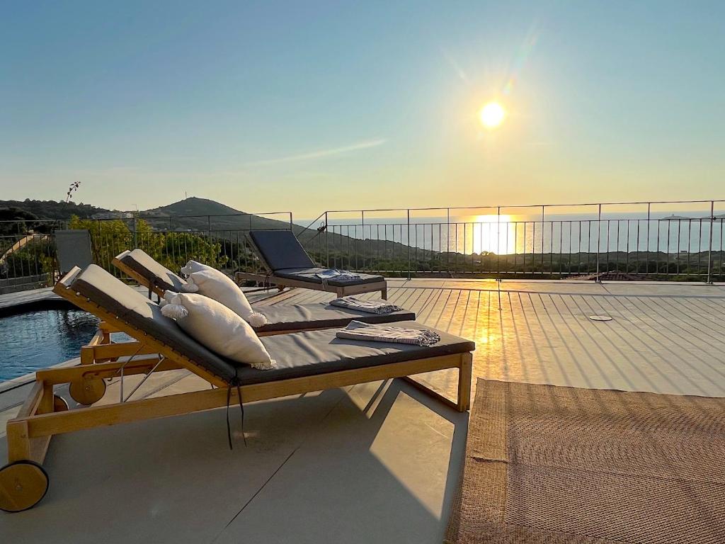 - une terrasse avec 2 chaises longues au-dessus d'un bâtiment dans l'établissement Villa San Joseph, à Cargèse