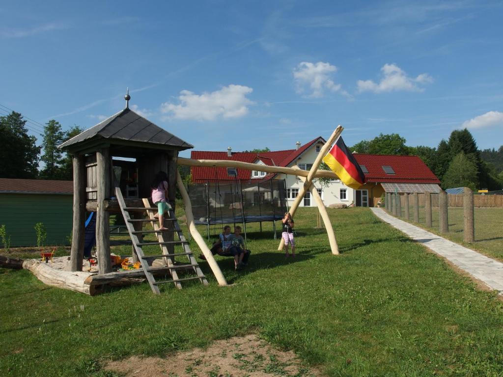 a playground with a slide in the grass at Ferienwohnungen Fischbachhof in Sulzbach an der Murr