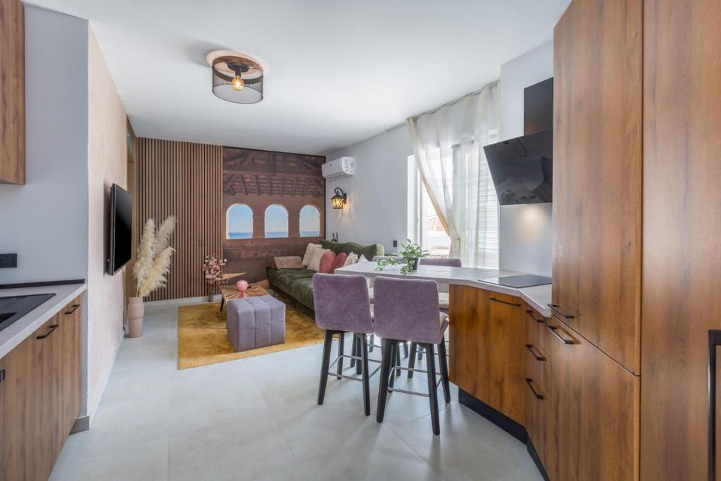 a kitchen with a bar and a living room at Apartment Belvedere by SeeAdria Agency in Novigrad Istria
