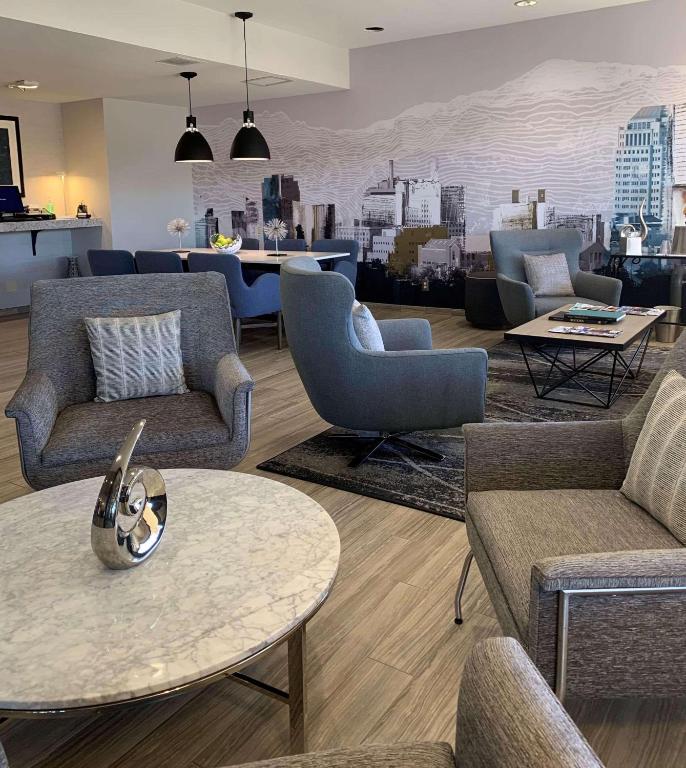a living room with couches and chairs and a table at Radisson Hotel Colorado Springs Airport in Colorado Springs