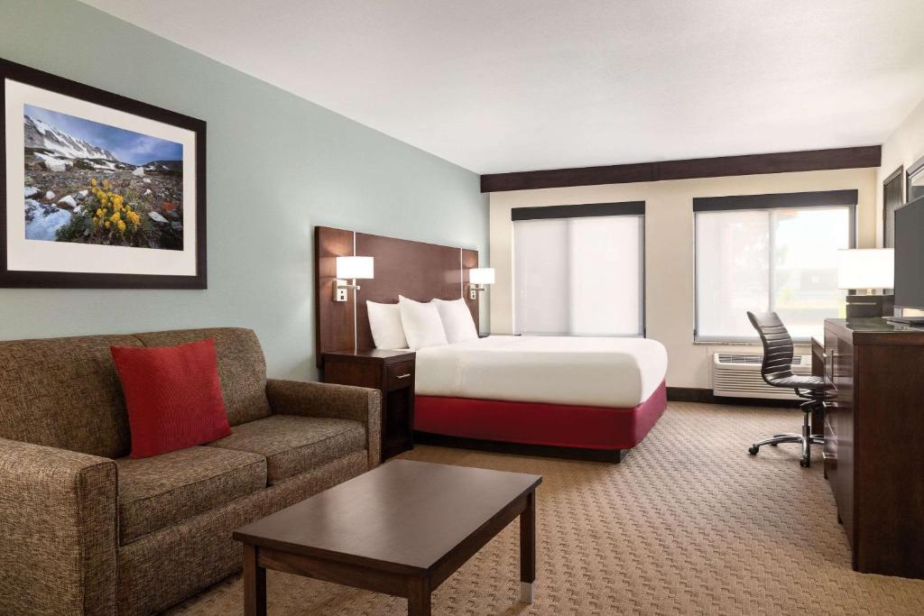 a hotel room with a bed and a couch at Radisson Hotel Colorado Springs Airport in Colorado Springs